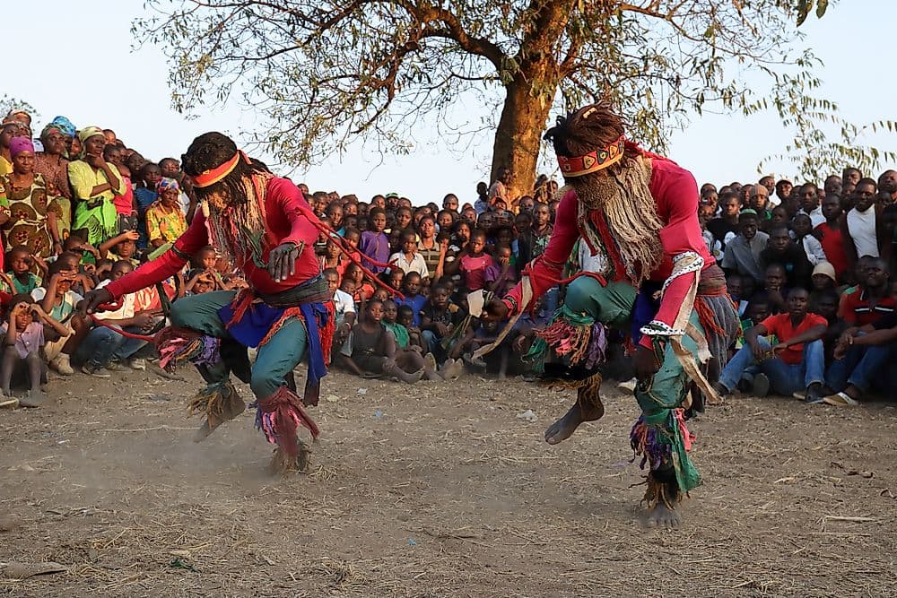 Local performers in colorful costumes dancing in a cultural festival in Malawi
